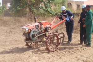Engineer Benjamin demonstrating the use of the smart tractor in soil tilling
